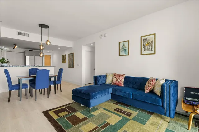 a living room with lots of furniture and a rug