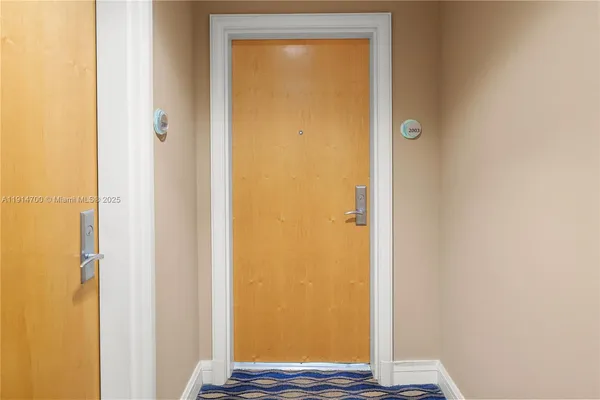 a view of front door with wooden floor