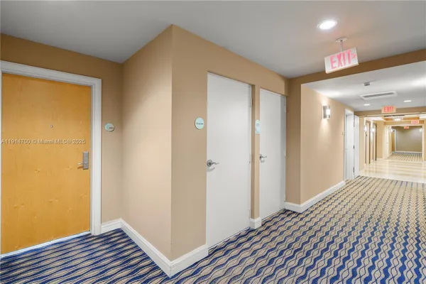 a view of a room with wooden floor and bathroom