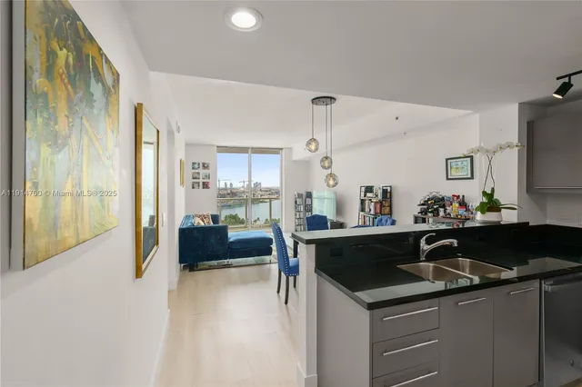 a kitchen with a sink and refrigerator