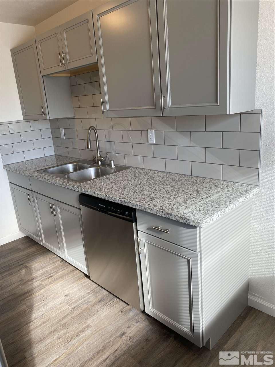 2197 Patton Drive Reno, NV 89512 - Photo 3 of 13 a kitchen with stainless steel appliances granite countertop a sink stove and cabinets