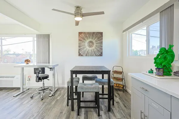 a view of a dining room with furniture and a potted plant
