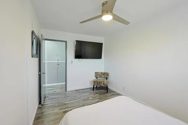 a bedroom with a bed and a flat screen tv
