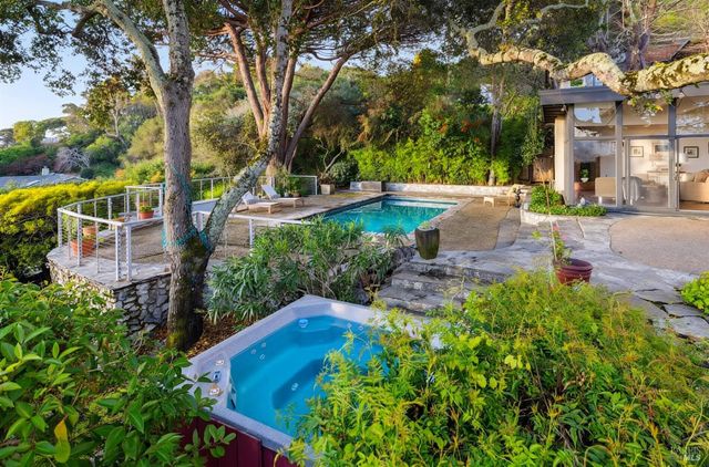 a swimming pool with outdoor seating and yard