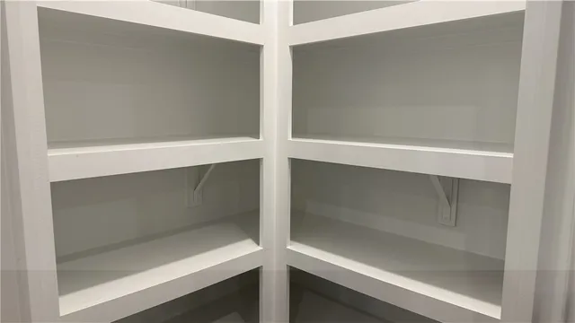 a kitchen with white cabinets and appliances