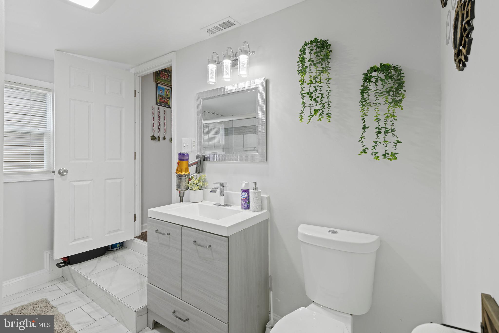 3512 Wagon Train Road Middle River, MD 21220 - Photo 15 of 27 a bathroom with a toilet sink and mirror