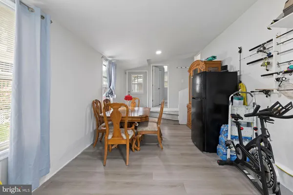 a dining room filled with furniture and a gym machine