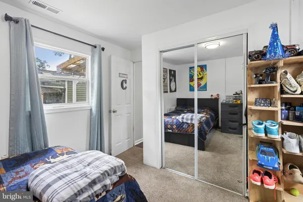 a bedroom with a bed and a couch