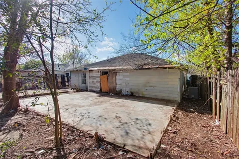 an aerial view of a house with a yard basket ball court and outdoor seating