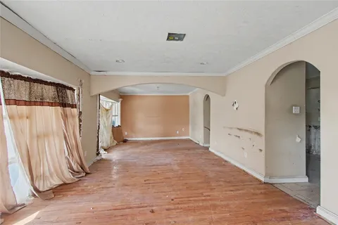 a view of a hallway with wooden floor and entryway