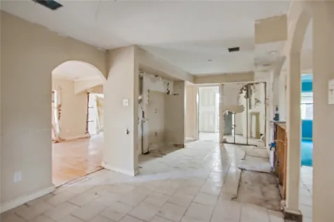 a view of a hallway with wooden shelves
