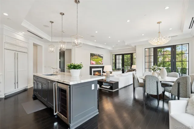 a living room with stainless steel appliances kitchen island granite countertop a stove and a view of living room