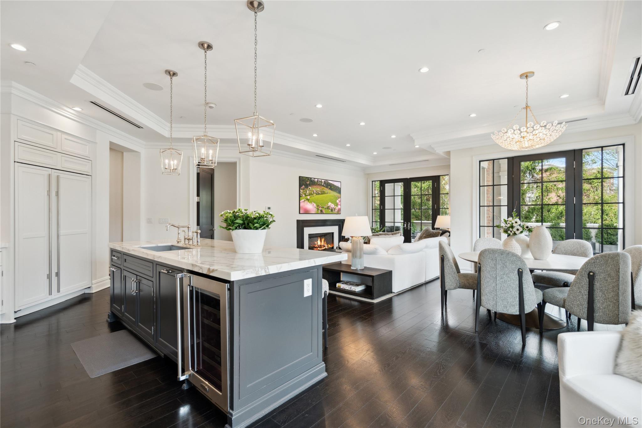 a living room with stainless steel appliances kitchen island granite countertop a stove and a view of living room