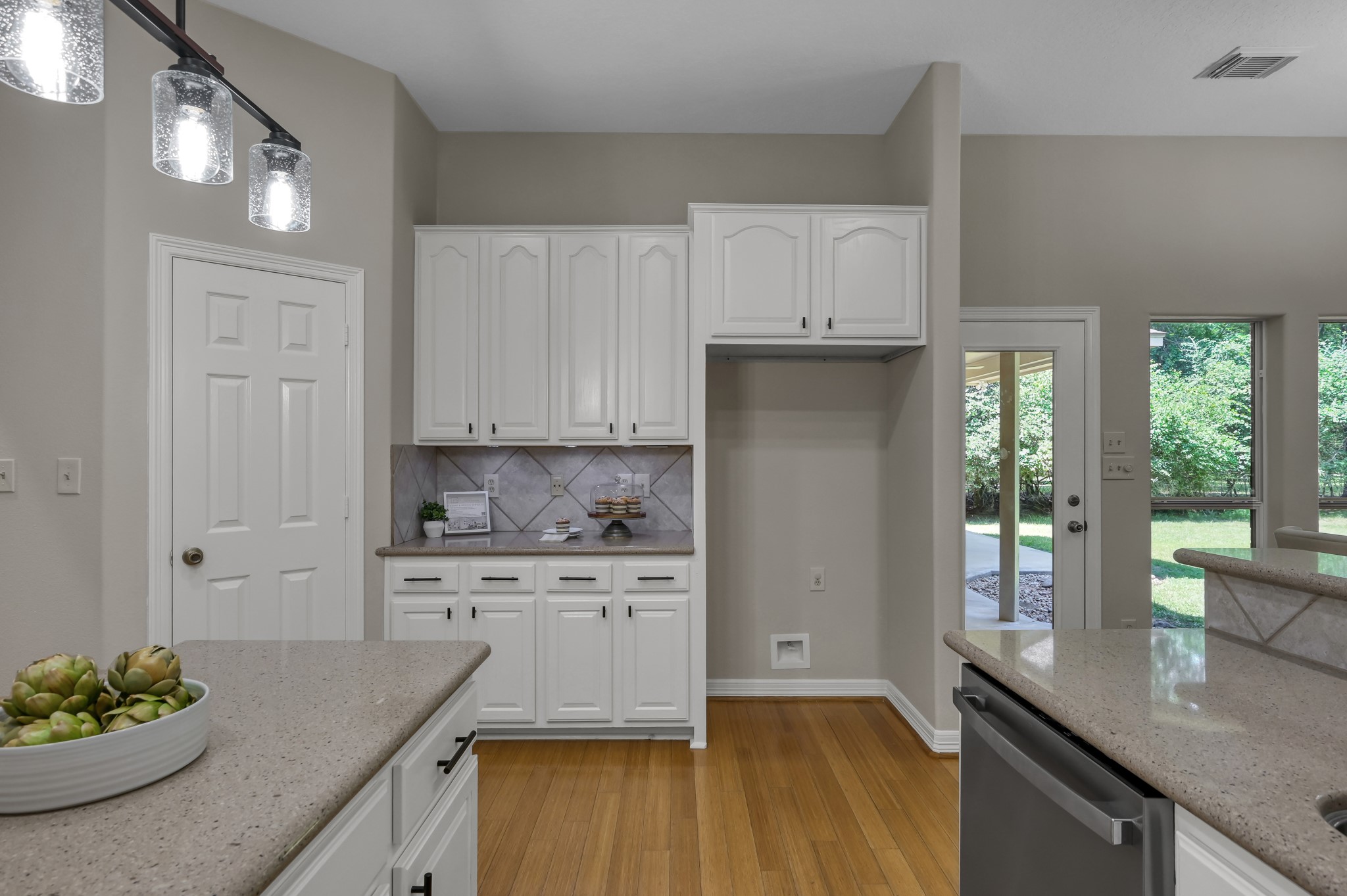 9606 Miller Road Magnolia, TX 77354 - Photo 16 of 41 Additional counterspace for a beverage/snack station is conveniently out of the way from cooking area. The large corner pantry is one of two storage closets.