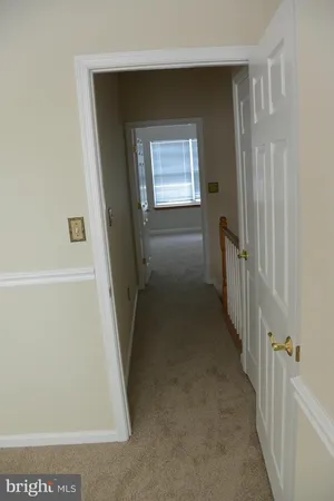 a view of a hallway with a white walls