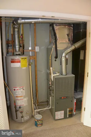 a room with water heater and a cabinet
