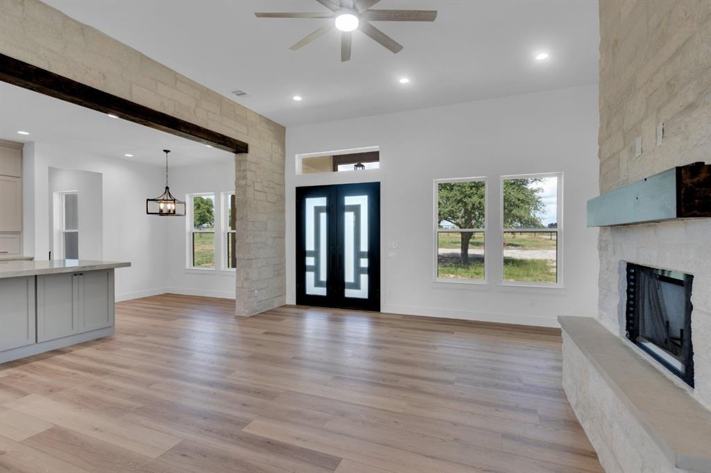 Tbd Hampel Road Palmer, TX 75152 - Photo 27 of 34 an empty room with wooden floor a fireplace and windows