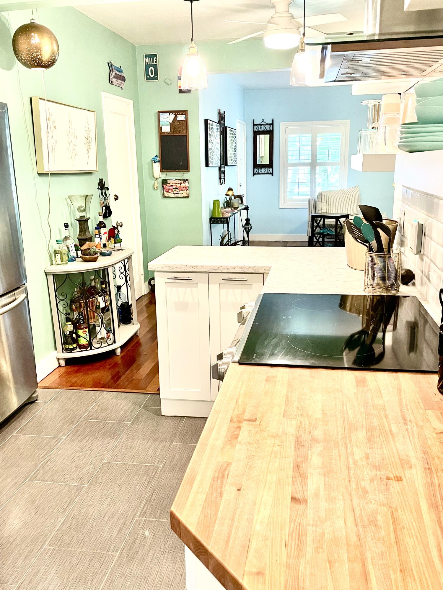804 South Street, Unit 1 Key West, FL 33040 - Photo 17 of 31 a view of a kitchen with kitchen island a sink wooden floor and counter top space