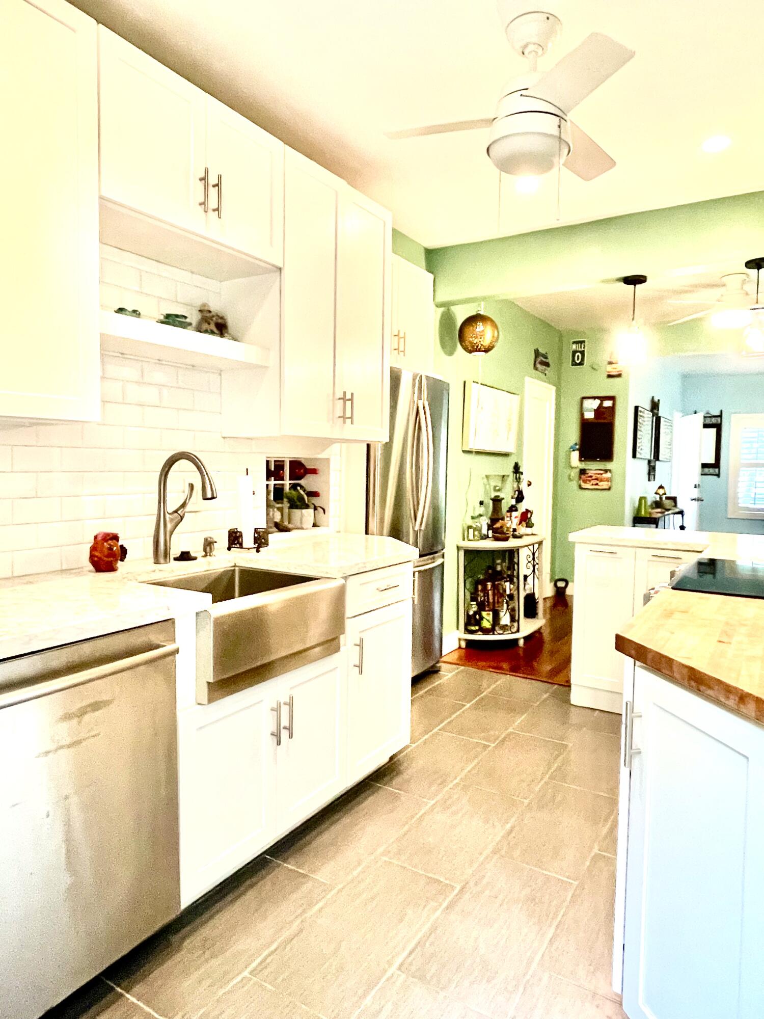 804 South Street, Unit 1 Key West, FL 33040 - Photo 19 of 31 a view of a kitchen with a sink and dishwasher a stove with wooden floor