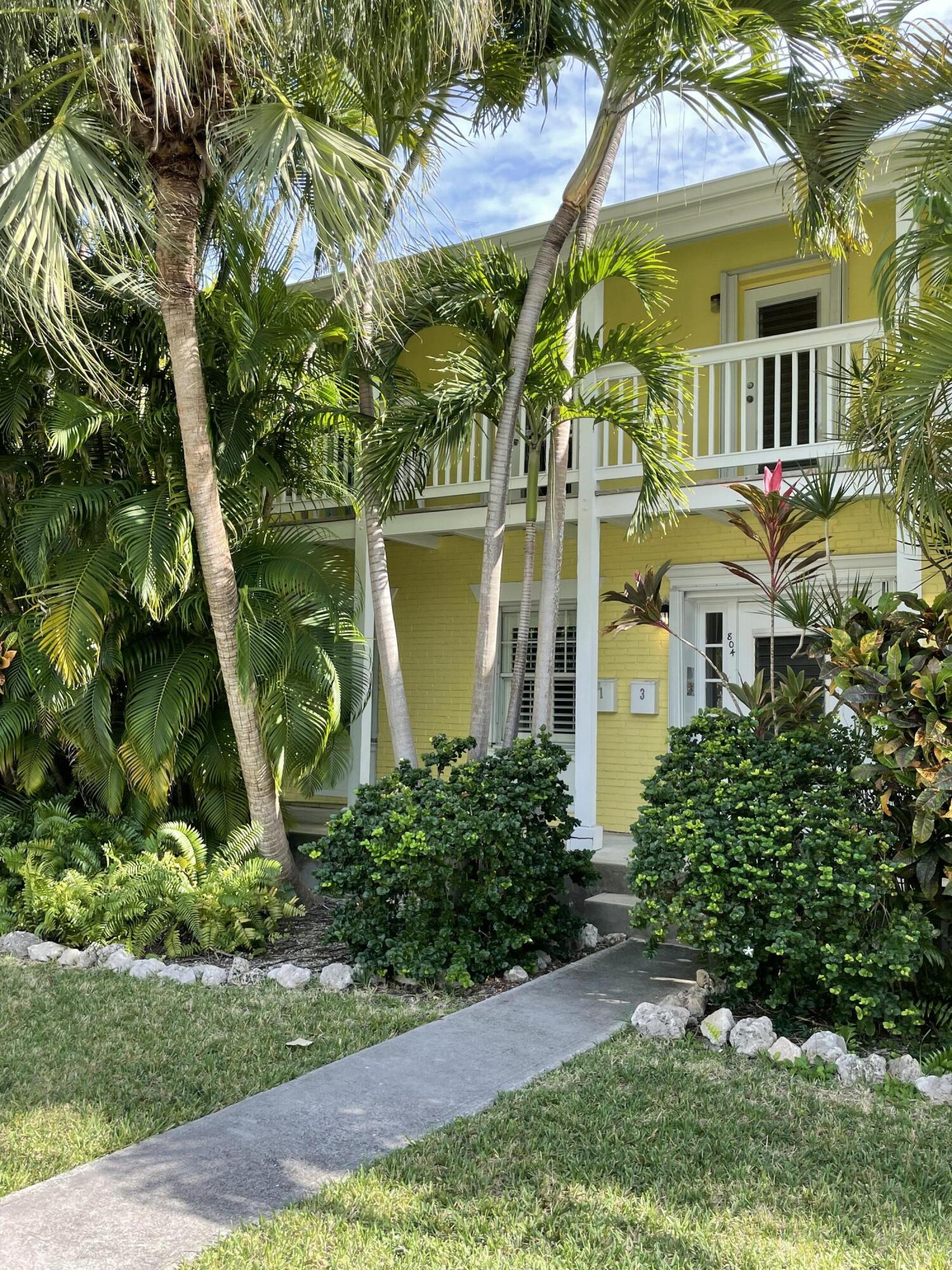 804 South Street, Unit 1 Key West, FL 33040 - Photo 2 of 31 a view of a multi story residential apartment building with a yard and plants