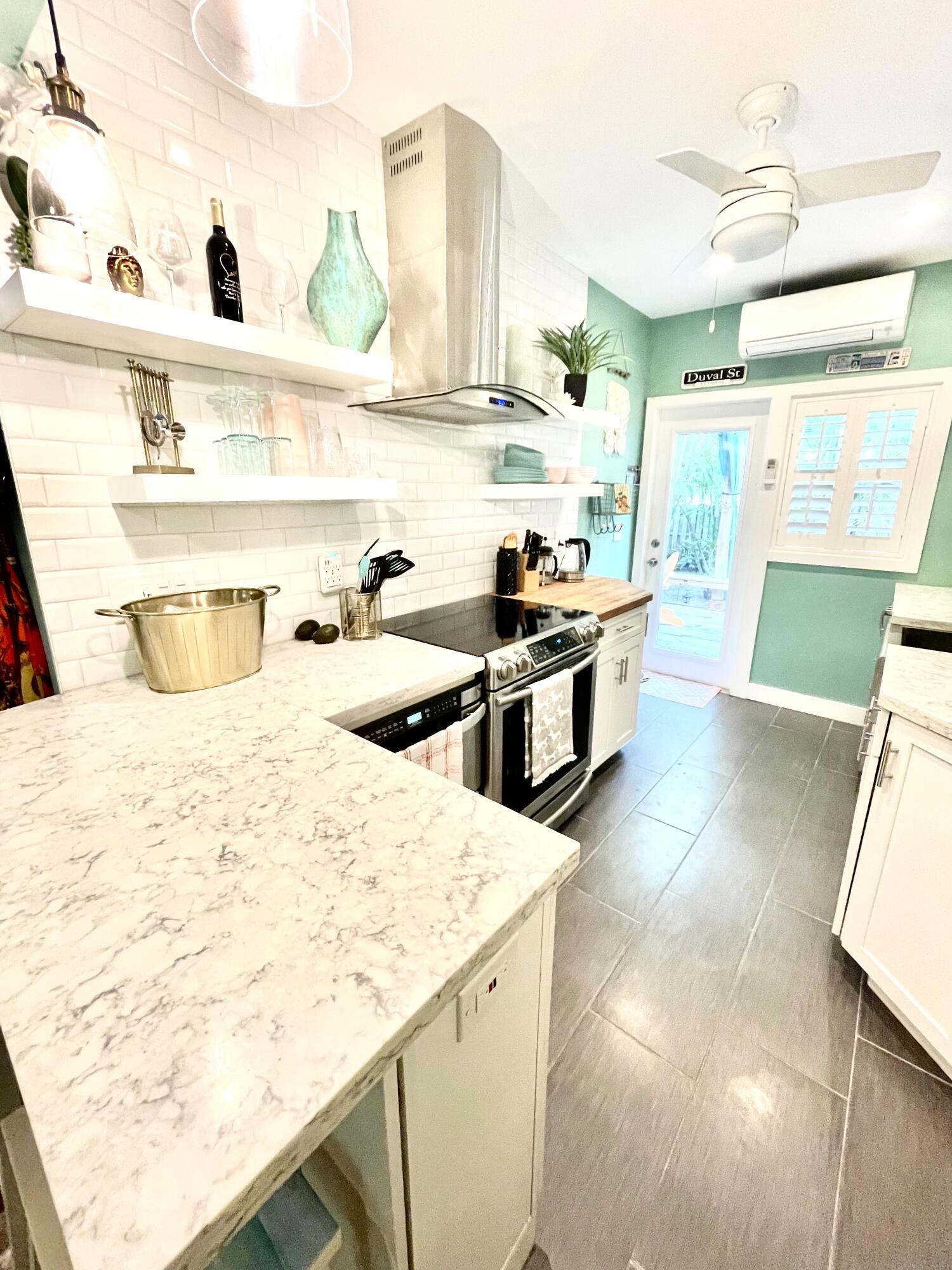 804 South Street, Unit 1 Key West, FL 33040 - Photo 21 of 31 a kitchen with stainless steel appliances kitchen island granite countertop a sink and a stove