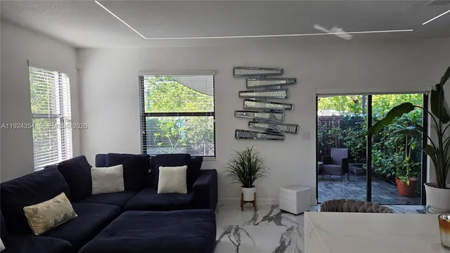 a living room with furniture and a large window