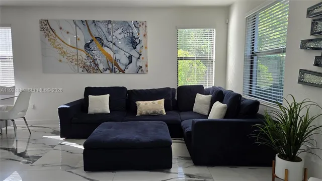 a living room with furniture and a large window