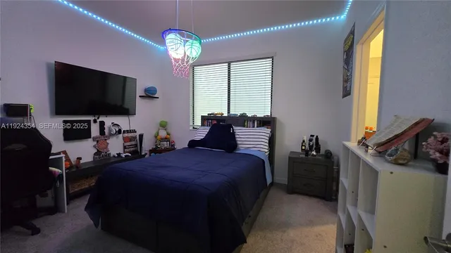 a bedroom with bed and a chandelier