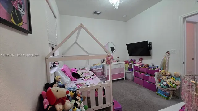 a bedroom with furniture and a flat screen tv