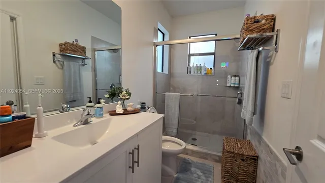 a bathroom with a sink toilet and shower