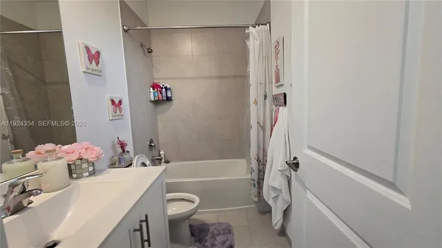 a bathroom with a sink vanity mirror and toilet