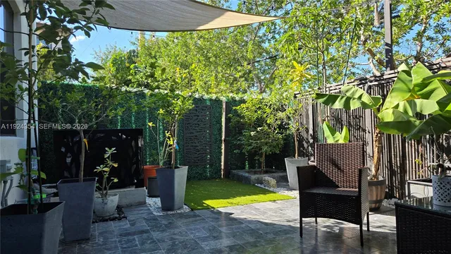 a view of a swimming pool with a patio and a yard