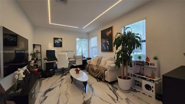 a living room with lots of furniture and a flat screen tv