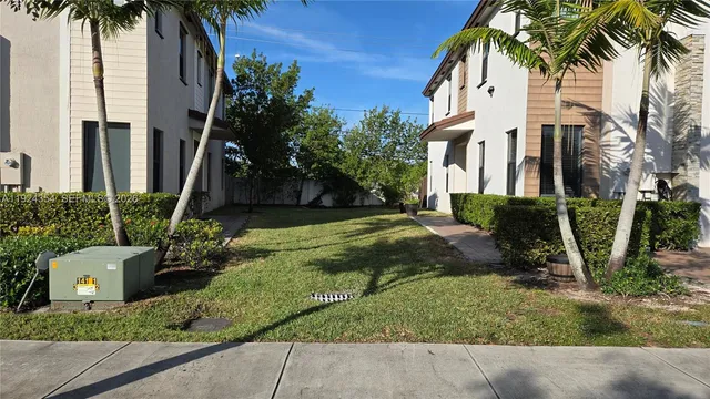 a view of street along with palm trees