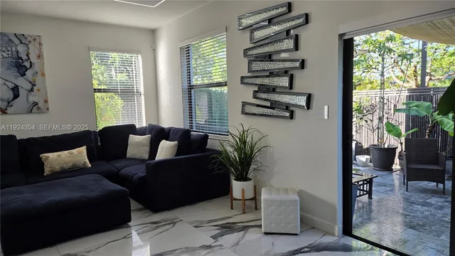 a living room with furniture and a large window