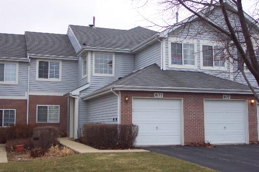 8175 Ripple Ridge, Unit 8175 Darien, IL 60561 - Photo 1 of 1 a front view of a house with a yard and garage