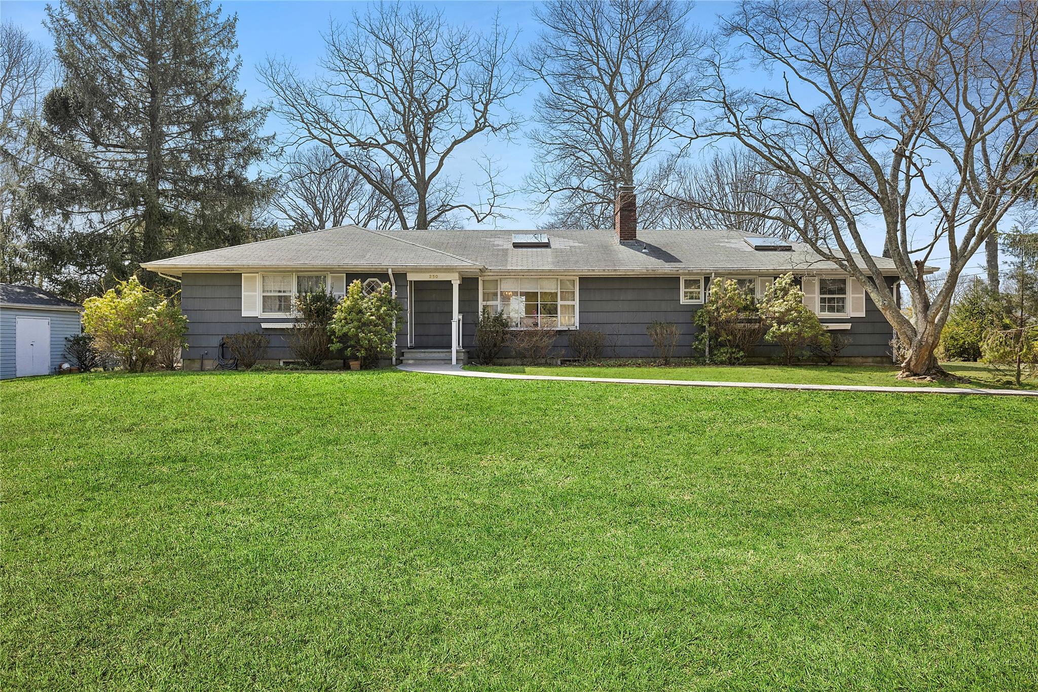 a front view of house with yard and green space