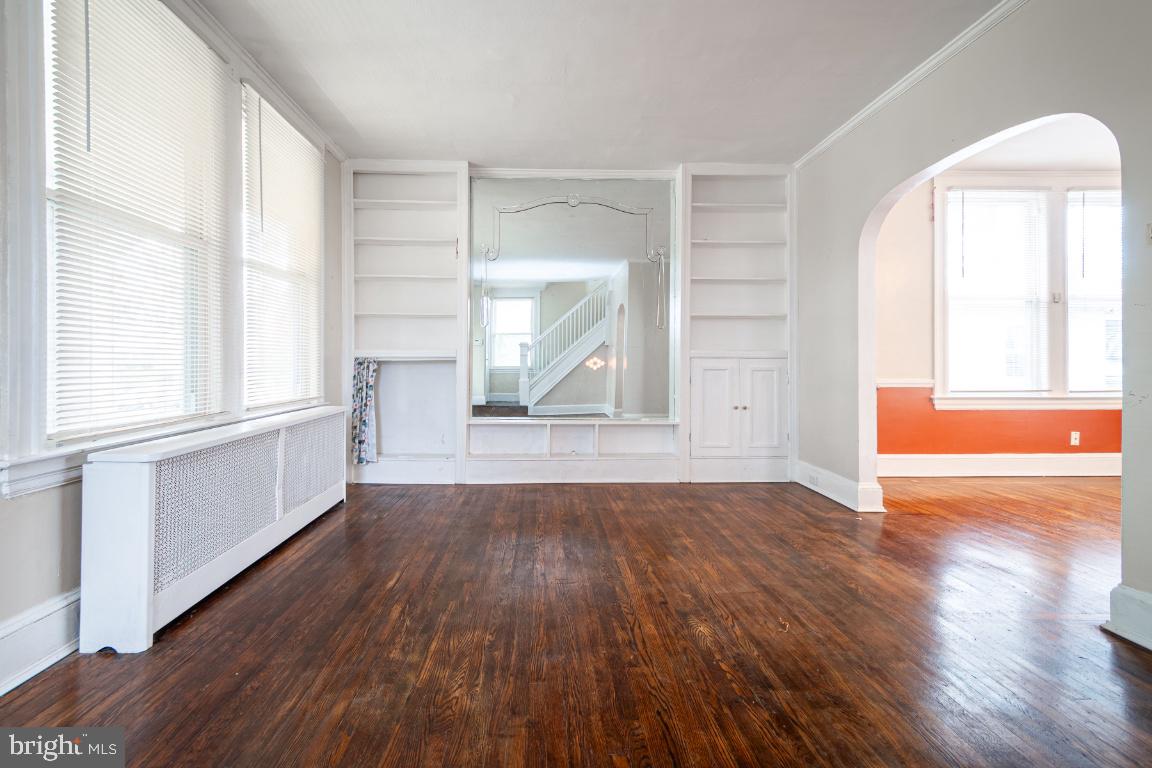 3312 Glen Avenue Baltimore, MD 21215 - Photo 11 of 25 an empty room with wooden floor and windows