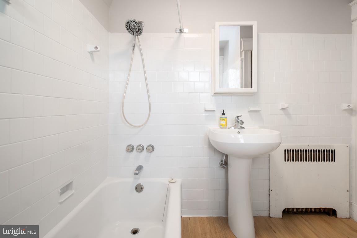 3312 Glen Avenue Baltimore, MD 21215 - Photo 17 of 25 a bathroom with a bath tub and a shower
