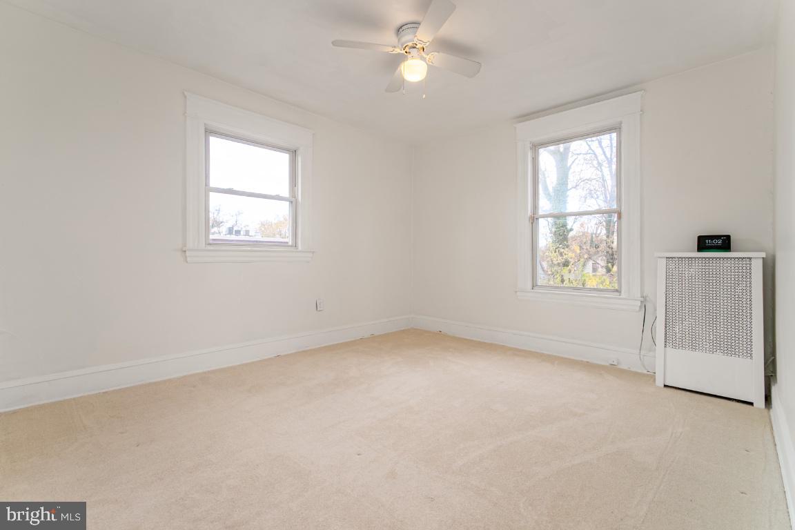 3312 Glen Avenue Baltimore, MD 21215 - Photo 18 of 25 an empty room with a window and a ceiling fan