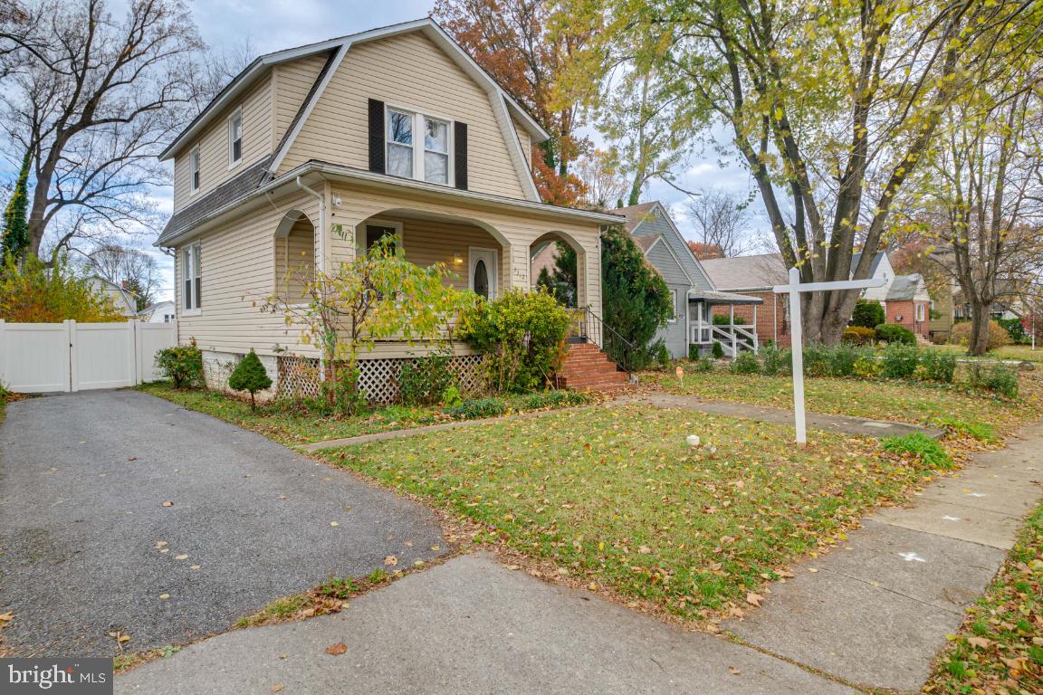 3312 Glen Avenue Baltimore, MD 21215 - Photo 2 of 25 a view of a white house with a large tree and a yard