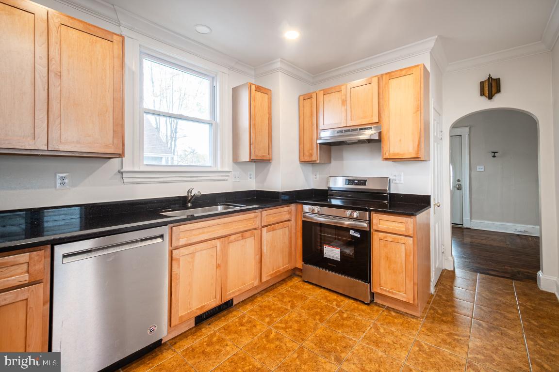 3312 Glen Avenue Baltimore, MD 21215 - Photo 7 of 25 a kitchen with stainless steel appliances granite countertop a stove a sink and a microwave