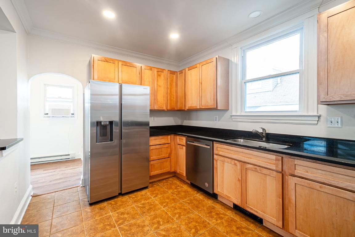 3312 Glen Avenue Baltimore, MD 21215 - Photo 8 of 25 a kitchen with stainless steel appliances granite countertop a refrigerator and a sink