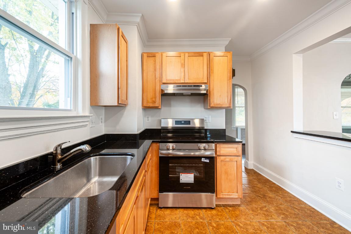 3312 Glen Avenue Baltimore, MD 21215 - Photo 9 of 25 a kitchen with a sink a stove and a refrigerator