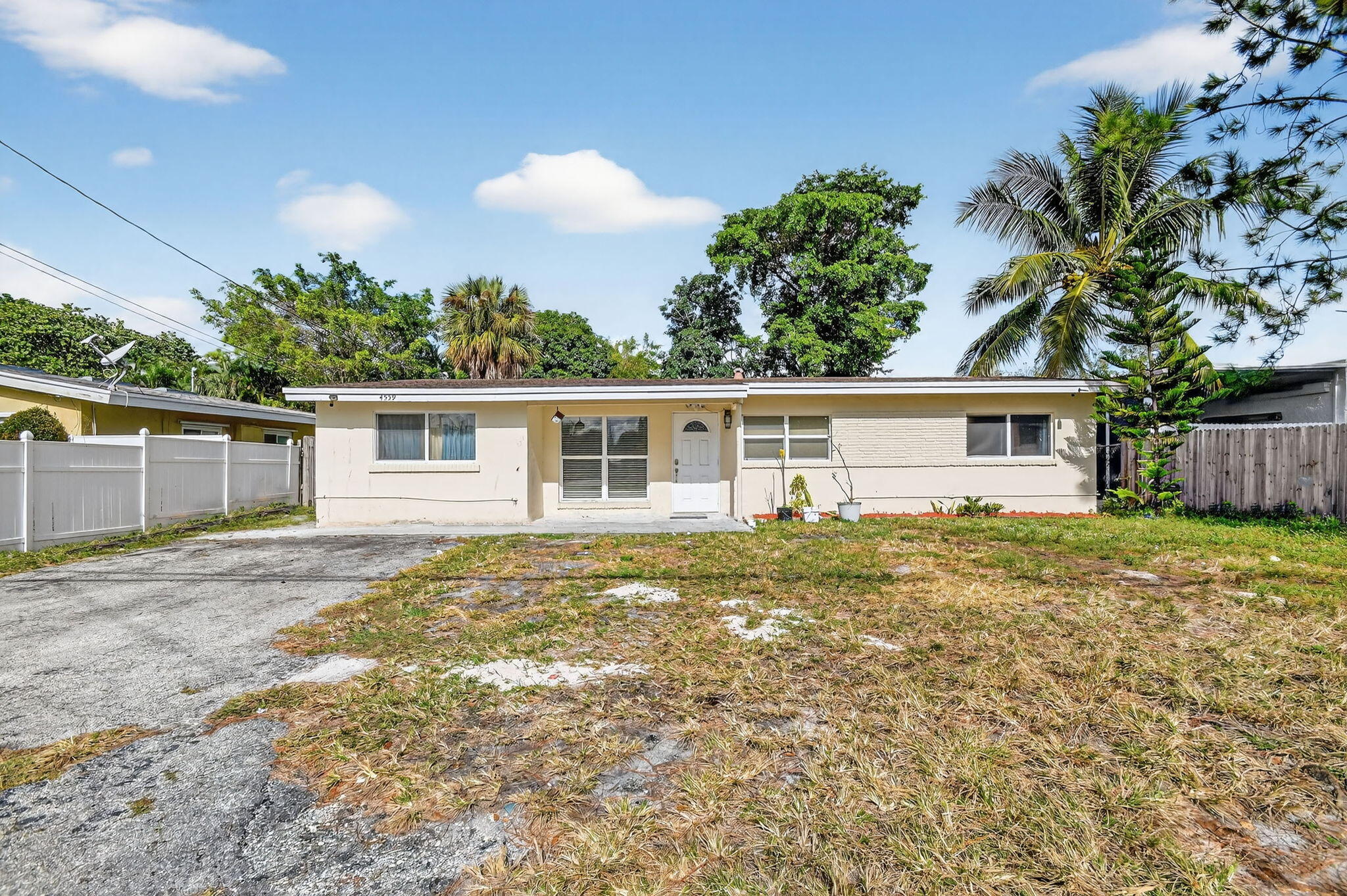 4559 Cole Street West Palm Beach, FL 33417 - Photo 2 of 72 a view of a yard in front of a house with a large tree