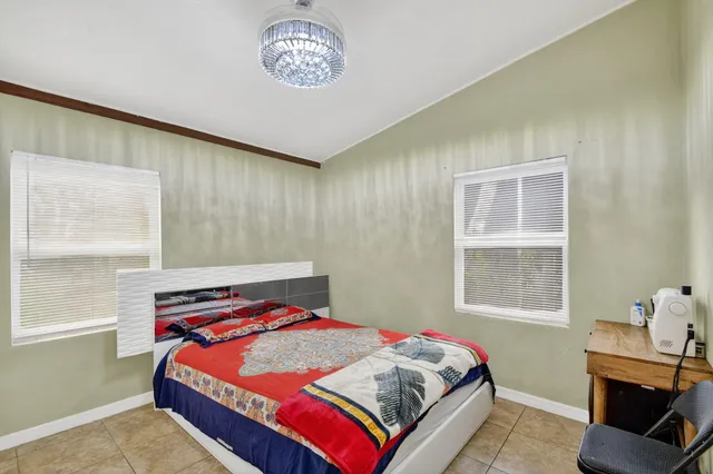 a bathroom with a granite countertop sink toilet a mirror and shower