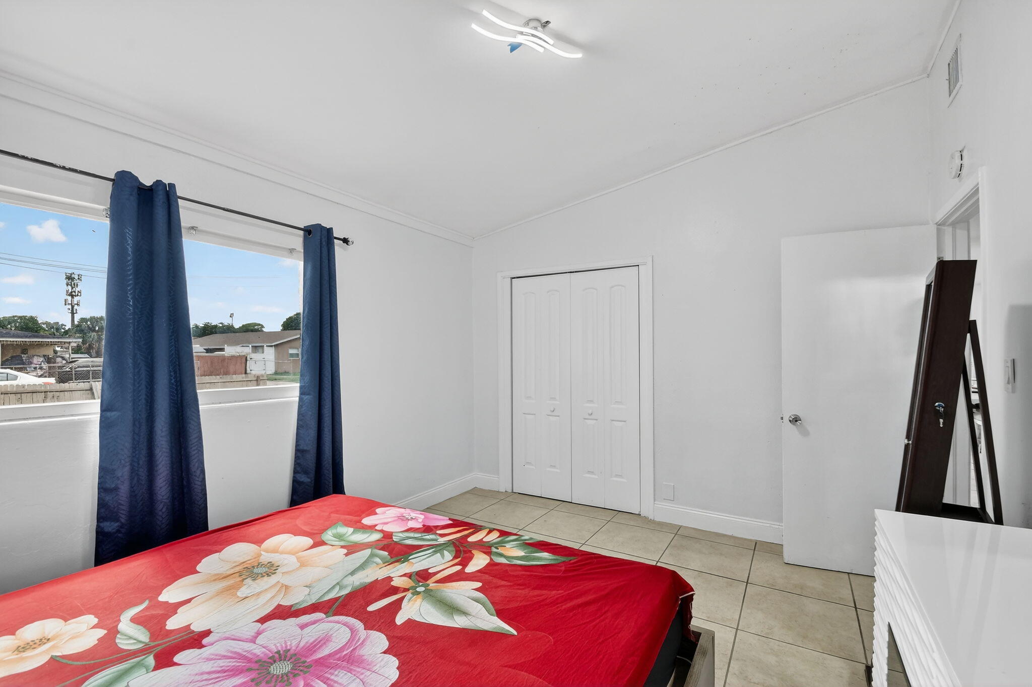 4559 Cole Street West Palm Beach, FL 33417 - Photo 28 of 72 a bedroom with a bed and a large mirror