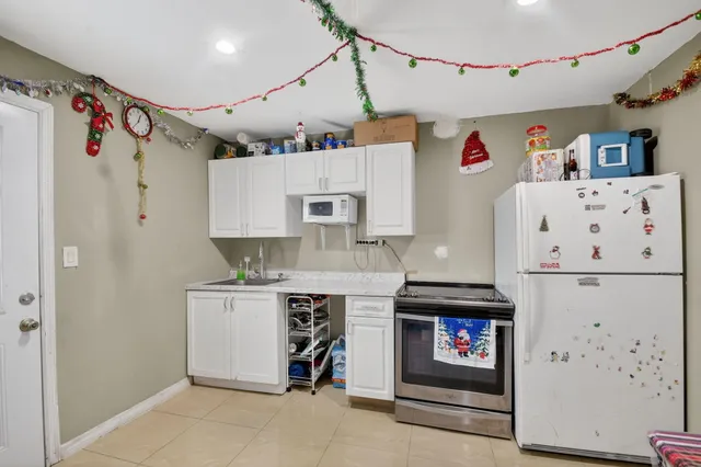 a kitchen with stainless steel appliances a stove refrigerator sink and cabinets