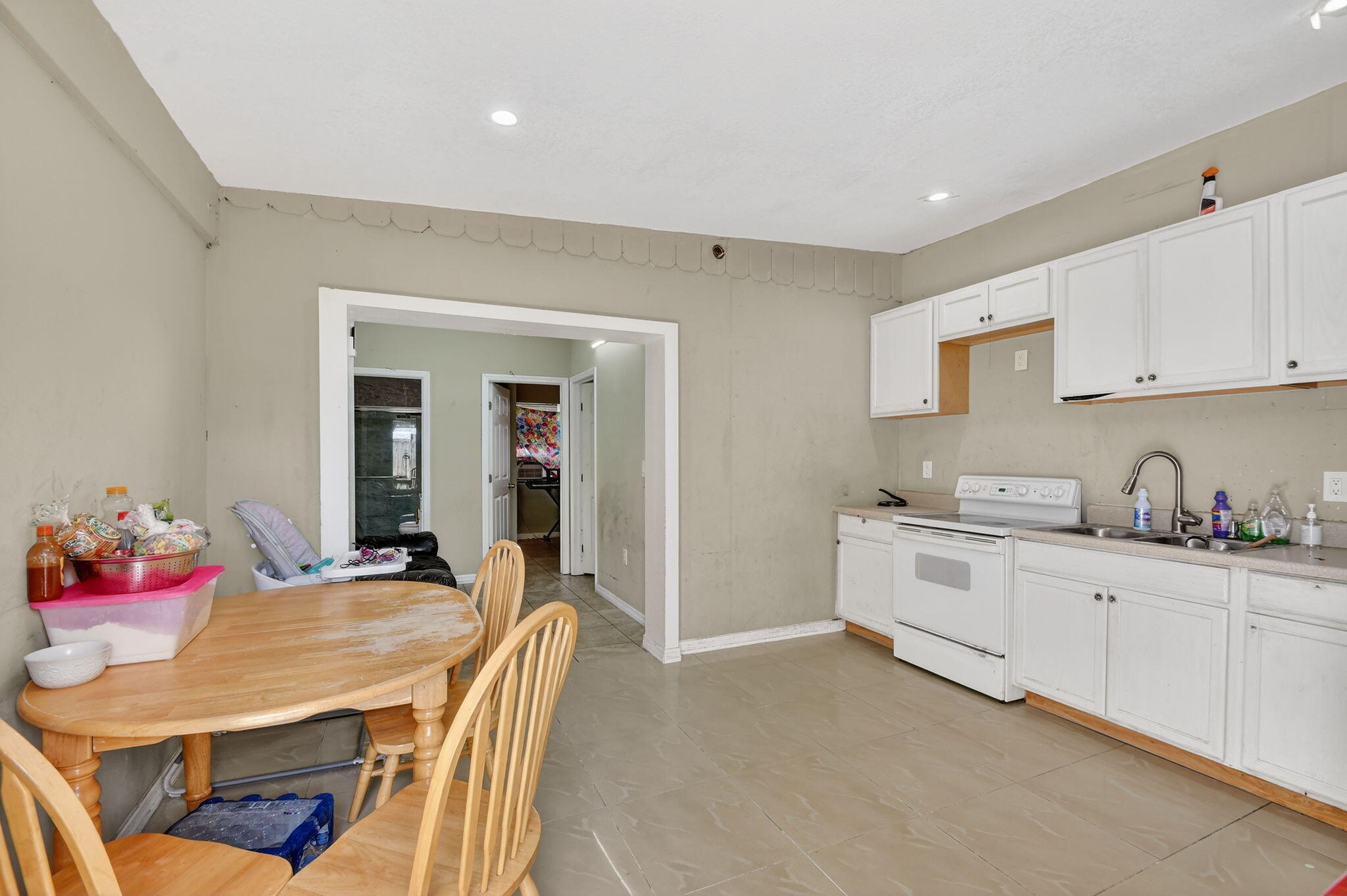4559 Cole Street West Palm Beach, FL 33417 - Photo 39 of 72 a kitchen with granite countertop a sink stove and cabinets