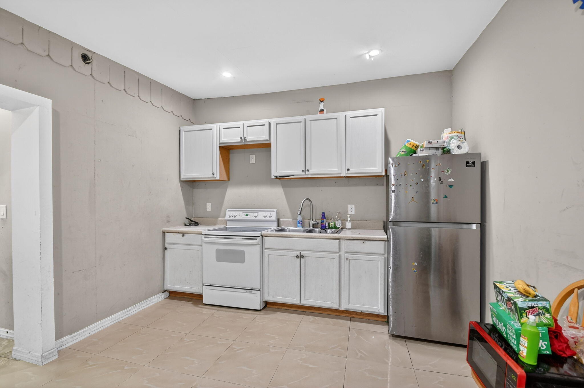 4559 Cole Street West Palm Beach, FL 33417 - Photo 41 of 72 a kitchen with stainless steel appliances a stove refrigerator sink and cabinets